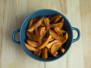 homemade serving of fries. French fries in a bowl on a wooden table.