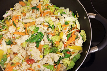 Chicken And Crispy Vegetable Stir Fry Cooking In A Wok Pan.