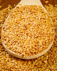 close up of sesame seeds on wooden spoon