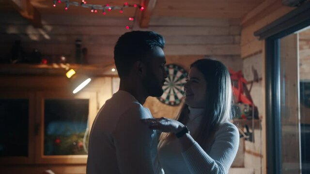 Happy young couple flirting and dancing at birthday party. Slow motion. High quality 4k footage