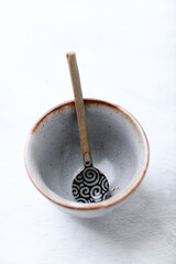 Traditional, handcrafted ceramic on bright wooden background. Soft focus. Close up.