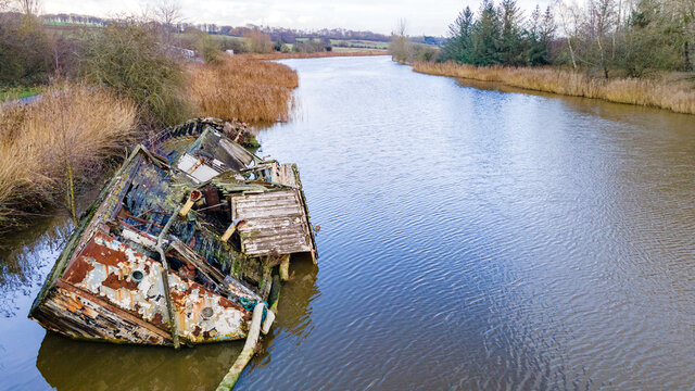 Shipwreck of "Chica" a boat on the river Weaver at Dutton Locks Northwich Cheshire. A wooden sail boat.