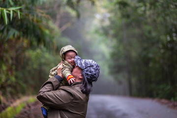 Happy family mother and baby hugging in Nature rainforest. Happy harmonious family outdoors.