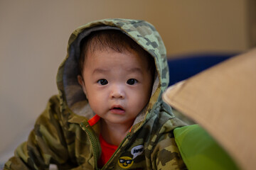 Cute Asian Baby boy with camouflage jacket