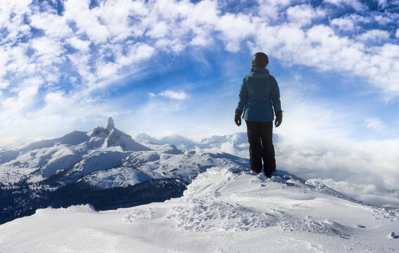 Adventurous Girl on top of a beautiful snowy mountain during a vibrant and sunny winter day. Blue Sky Art Render. Taken in Whistler, British Columbia, Canada.