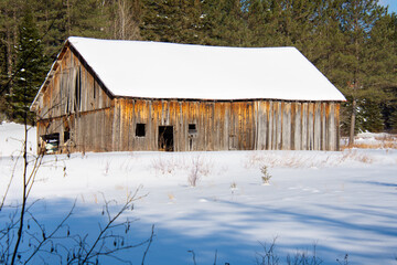 Old barn in a field during Quebec winter in Canada