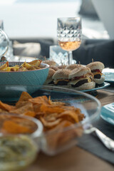 a set of food, mini burgers, nachos,salad,.