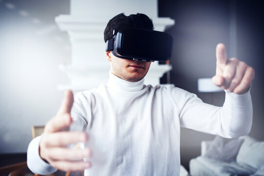 the programmed screen graph is in the air. watches videos and works in virtual reality. 3d glasses of black color on the face. 5G data transmission modern digital technology is available. - Powered by Adobe