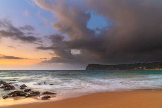 Sunrise at the seaside with rain clouds rolling in