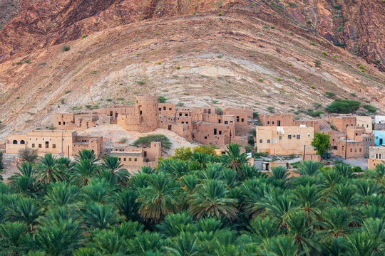 Palm trees and a traditional mountain village in Nizwa,Oman.