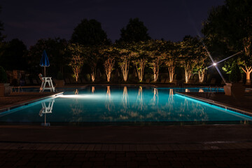 A swimming pool lit up for a night swim.