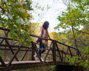 Girl on bridge in nature. 
