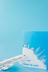 Passport and airplane on light blue background.Summer or vacation concept. Copy space.
