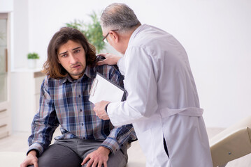 Young male patient visiting experienced doctor psychiatrist