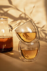 Double-bottom glasses are stacked on top of each other. Natural motives in warm colors. Breakfast glasses with tea.