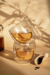 Double-bottom glasses are stacked on top of each other. Natural motives in warm colors. Breakfast glasses with tea.