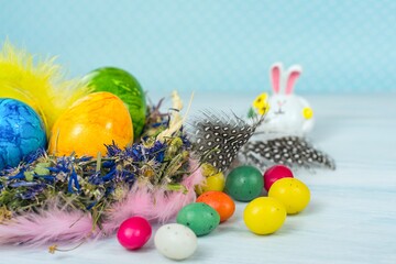 Fototapeta na wymiar spring background with Easter egg in the nest and rabbit