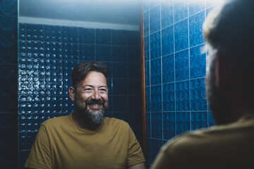 happy smiling man looking at the mirror