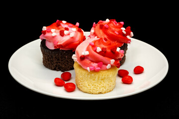 Valentine's day cupcakes with candy in a white plate