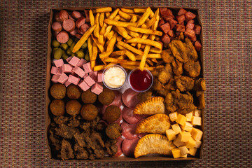 A wide variety of snacks in a cardboard tray