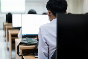Blur and selective focus of the university student using computer studying in the computer room....