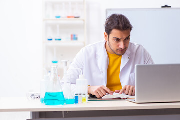 Young male chemist student preparing for exam