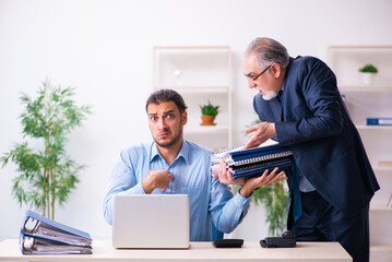 Old boss and his young assistant in the office