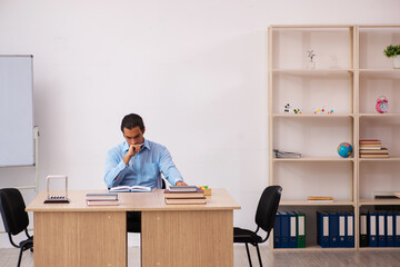 Young male teacher in the classroom