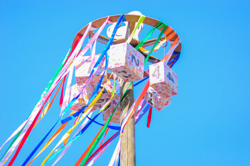 Fototapeta premium Maslenitsa. Competition for the agile. On a background of blue sky.