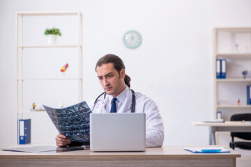 Fototapeta premium Young male doctor radiologist working in the clinic