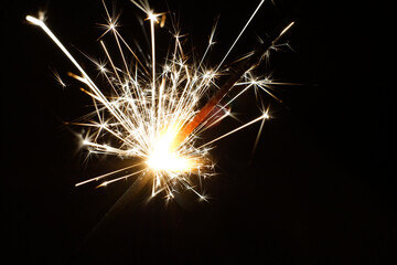 Bright sparks in total darkness. Closeup.