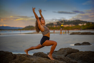 Fototapeta na wymiar Woman practicing yoga on the beach at sunset