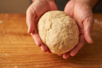 cook kneads his preparation before baking