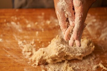 cook kneads his preparation before baking