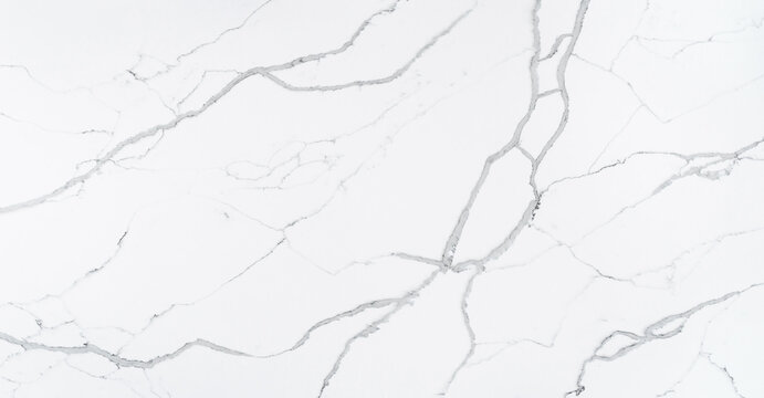 This quartz slab is designed to mimic the look of Statuario Marble. It contains bold grey veins which are outlined in a cool-toned dark grey with subtle grey shoelace veins for a natural look.