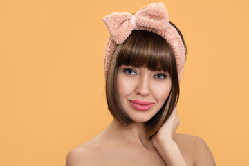 cute young woman with a pink bow on her head. Skin and face care concept. copycpase