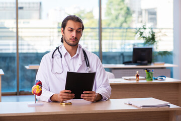 Young male doctor cardiologist working in the clinic