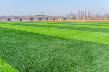 Fototapeta premium Football pitch and a cloudy sky. Green field.