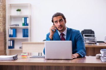 Young male employee working at workplace