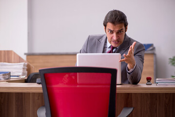Young businessman employee in bullying concept in the office