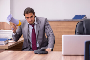 Young businessman employee in bullying concept in the office