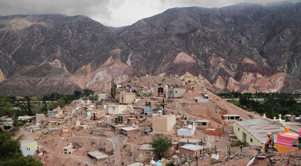 Religion and culture. Ancient aboriginal cemetery at the foot of the Andes mountains in Maimará, Jujuy, Argentina. The colorful rocky canyon and tombstones along the hills.