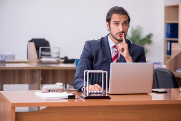 Young man businessman employee sitting in the office