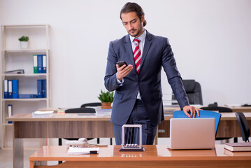 Young man businessman employee sitting in the office