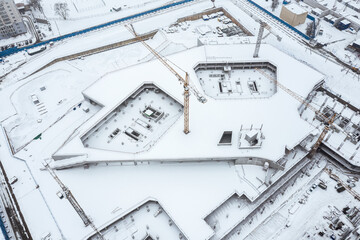 aerial view of building multi-level monolithic foundation. big construction site at winter time.