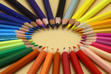 Colored pencils placed in a circle, empty space to place text