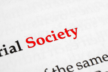 Selective focus on the red word society. Macro shot printed red colour word Society on a piece of paper.
