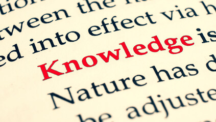 Selective focus on the red word knowledge. Macro shot printed red colour word Knowledge on a piece of paper.