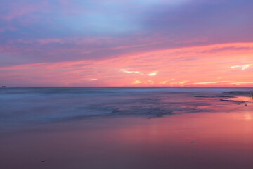 Colorful sunrise sky over the coast.