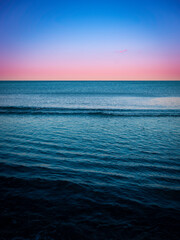 Tranquil Seascape at Twilight with Diverging Wave Patterns